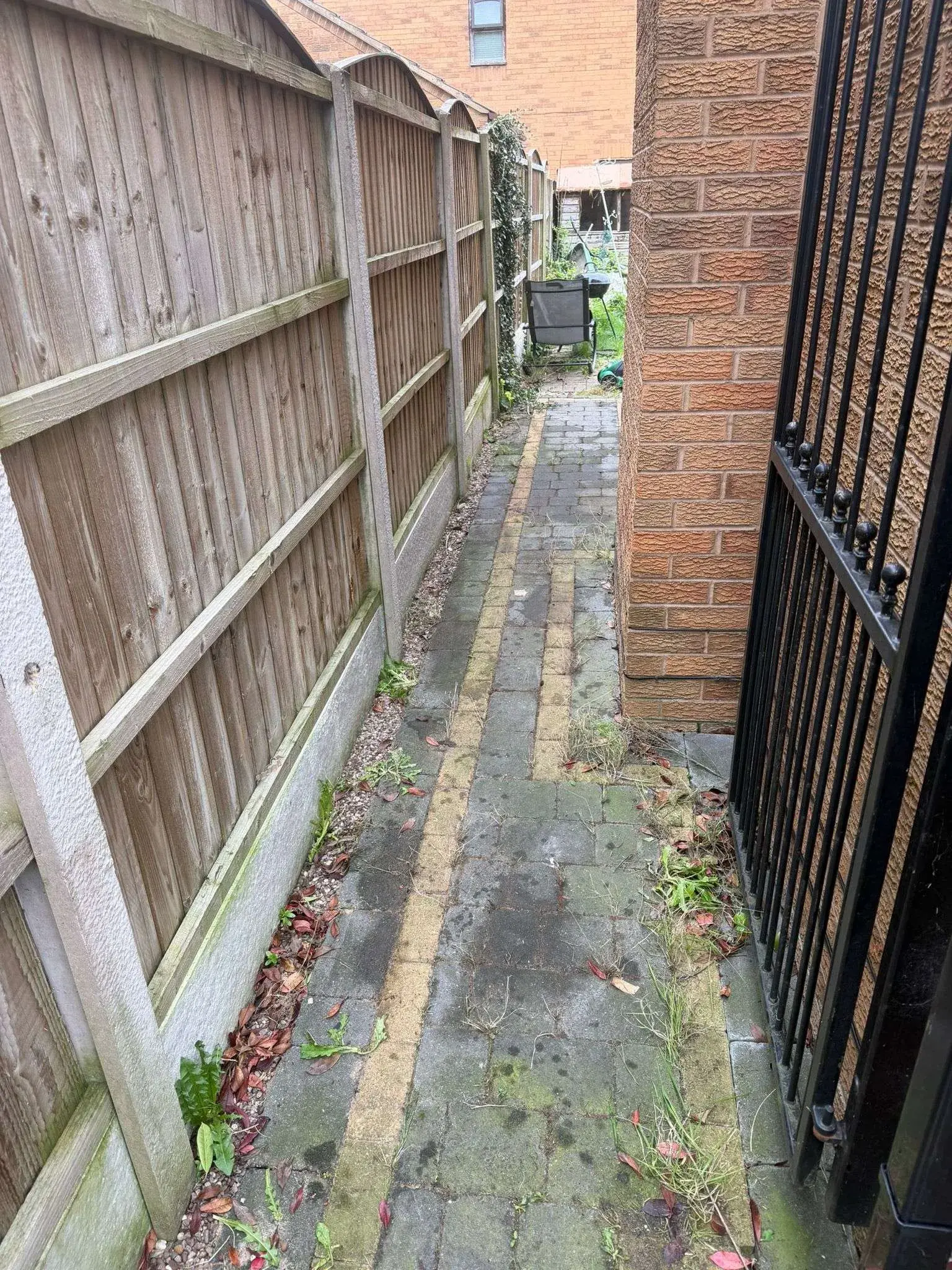 Side of house after waste clearance